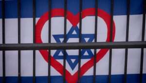 A heart seen painted on the Israeli flag, in Jerusalem. December 25, 2023. Photo by Chaim Goldberg/FLASH90