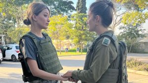 Sarah Idan (left) speaks with an IDF captain at the ruins of Kibbutz Kfar Aza, near the Gaza Strip, Dec. 28, 2023. Source: X.