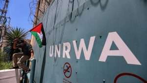 A Palestinian man outside the United Nations Relief and Works Agency for Palestine Refugees in the Near East (UNRWA) in Gaza City protests cuts to aid on June 20, 2023. Credit: Anas-Mohammed/Shutterstock.