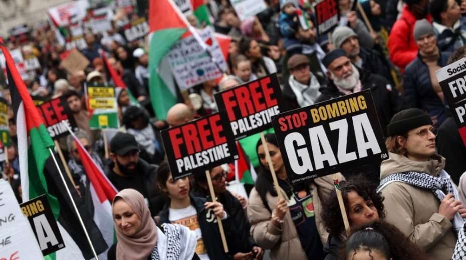Pro-Palestinian protesters carry placards during a 'National March for Palestine' demonstration in central London. EPA-EFE/ANDY RAIN