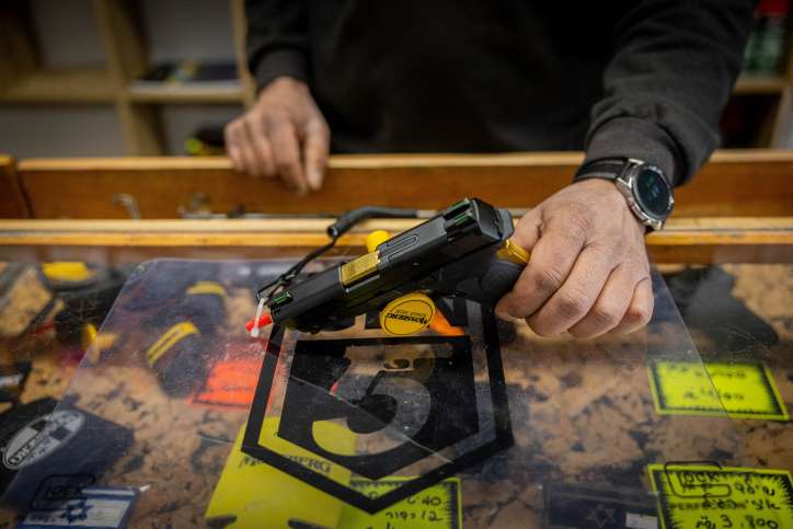A Vendor sells guns at Jerusalem shooting range, following the recent wave of terror attacks in Israel. April 3, 2022. Photo by Yonatan Sindel/Flash90