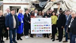 Legislators from around the world sign a call to defund and dismantle UNRWA, during a tour of Kibbutz Kfar Aza near the Gaza Strip, March 3, 2024. Credit: Israel Allies Foundation.