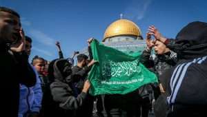 Palestinians hold a Hamas flag, rallying in support of terrorism at the Temple Mount in the Old City of Jerusalem on Jan. 27, 2023. Photo by Jamal Awad/Flash90.