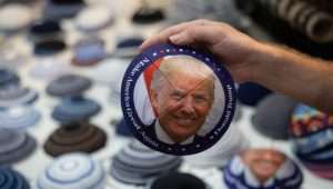 A man sells a yarmulke with a picture of former US President Donald Trump at the Mahane Yehuda Market in central Jerusalem on August 27, 2023. Photo by Chaim Goldberg/Flash90