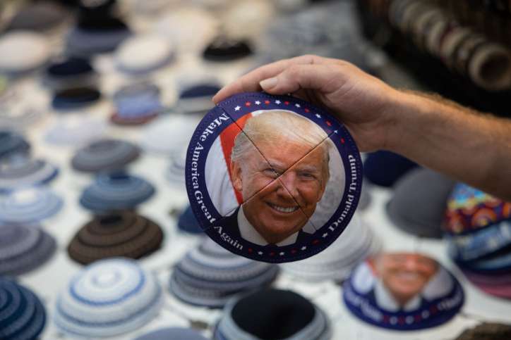 A man sells a yarmulke with a picture of former US President Donald Trump at the Mahane Yehuda Market in central Jerusalem on August 27, 2023. Photo by Chaim Goldberg/Flash90