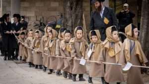 Jewish children from the Boyan Dynasty march before the Jewish festival of Purim in the Mea Shearim neighborhood of Jerusalem on March 18, 2024. Photo by Chaim Goldberg/Flash90