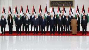 Palestinian leader Mahmoud Abbas (C) and ministers of the reshuffled government pose for a family photo after the swearing-in ceremony in the city of Ramallah, March 31, 2024. Photo: EPA-EFE/ALAA BADARNEH
