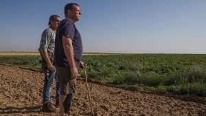 Avida Bachar surveys the fields at Kibbutz Be'eri, April 15, 2024. Photo by Rina Castelnuovo.