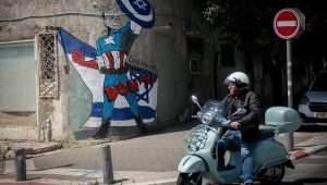 A large wall mural near Kibbutz Galuyot in Tel Aviv, depicting U.S. President Joe Biden as a superhero defending Israel. April 15, 2024. Photo by Miriam Alster/Flash90.