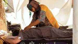 Dor Kapah gives a massage to a music festival participant. Photo by Inor Kagno.