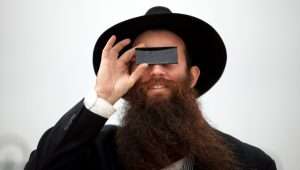 An Orthodox Jewish man watches a solar eclipse in Jerusalem on January 04, 2011. Photo by Abir Sultan/Flash90