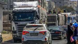 Armed and masked Palestinians seen on trucks loaded with international humanitarian aid entering Gaza through the Israeli Kerem Shalom Crossing, in the southern Gaza Strip, April 3, 2024. Photo by Abed Rahim Khatib/Flash90.