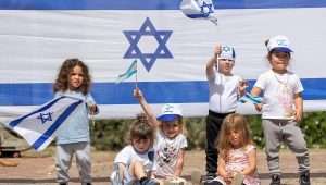 Israeli children play with Israeli flags ahead of Israel's 75th Independence Day, at Kobi kindergarden in Moshav Yashresh, on April 19, 2023. Photo by Yossi Aloni/Flash90.