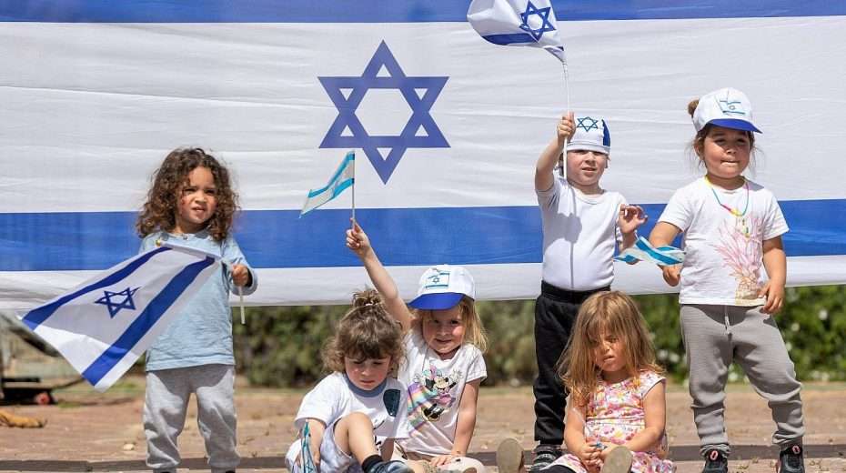 Israeli children play with Israeli flags ahead of Israel's 75th Independence Day, at Kobi kindergarden in Moshav Yashresh, on April 19, 2023. Photo by Yossi Aloni/Flash90.