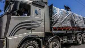 Terrorists on trucks loaded with aid entering Gaza through Israel's Kerem Shalom Crossing, April 3, 2024. Photo by Abed Rahim Khatib/Flash90.