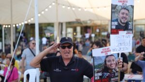 People hold up pictures of freed hostages and celebrate at Hostages Square in Tel Aviv, Israel, June 8, 2024. Photo: EPA-EFE/ABIR SULTAN