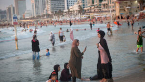 Arab women enjoy the beach in Tel Aviv on August 4, 2020. Photo by Miriam Alster/Flash90