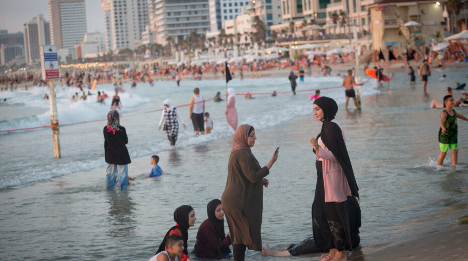 Arab women enjoy the beach in Tel Aviv on August 4, 2020. Photo by Miriam Alster/Flash90