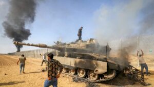 Palestinians take control of an Israeli tank after crossing the border fence with Israel from Khan Yunis in the southern Gaza Strip, Oct. 7, 2023. Photo by Abed Rahim Khatib/Flash90.