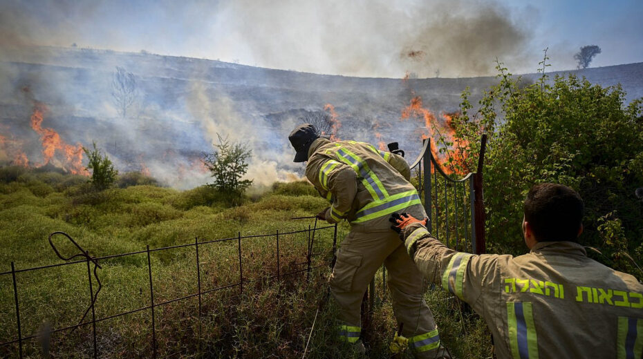 Israeli firefighters try to extinguish a fire sparked by missiles launched from Lebanon, near the northern city of Safed, June 12, 2024. Photo by Michael Giladi/Flash90.