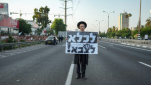 "To jail, and not to the army!" Orthodox Jews protest the ruling that they must do military service, arguing that it impedes their study of the Bible. Photo by Erik Marmor/Flash90