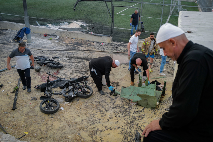 Local Druze residents and Israeli rescue personnel clean up the aftermath of the Majdal Shams massacre. Photo by Michael Giladi/Flash90