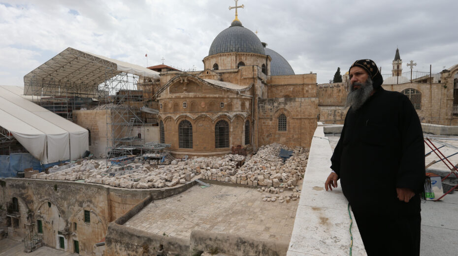 A Coptic priest looks at the Church of the Holy Sepulchre in the Old City of Jerusalem. Photo by Nati Shohat/Flash90.