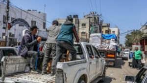Armed and masked Palestinians on trucks loaded with humanitarian aid entering Gaza through the Israeli Kerem Shalom Crossing, in the southern Gaza Strip, April 3, 2024. Photo by Abed Rahim Khatib/Flash90.