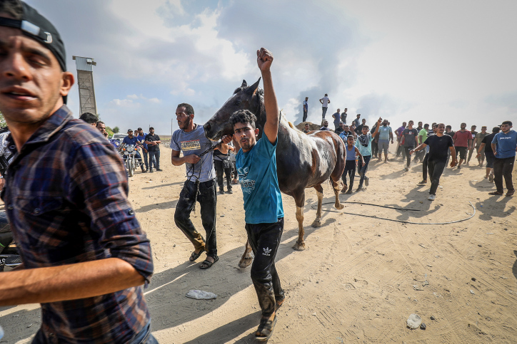 Palestinians near the border fence with Israel from Khan Yunis in the southern Gaza Strip, October 7, 2023. Photo by Abed Rahim Khatib/Flash90