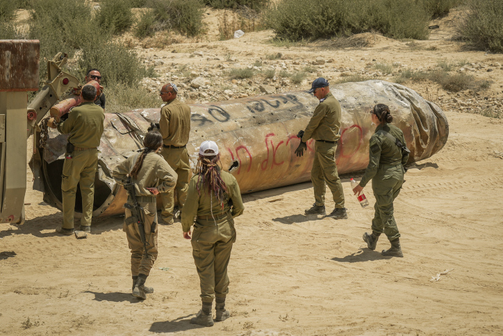 Israeli soldiers remove the remains of a missile fired from Iran, near the southern Israeli city of Arad, May 2, 2024. Photo by Erik Marmor/Flash90