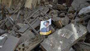 A picture of slain Hezbollah leader Hassan Nasrallah over the rubble of a damaged building after an Israeli airstrike in Al Mreijeh, in the southern suburbs of Beirut, Lebanon, October 4, 2024. Photo: EPA-EFE/WAEL HAMZEH