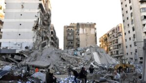 People inspect the site of an Israeli airstrike on a branch of the Al-Qard Al-Hassan financial group in Al-Shiyah, Beirut, Lebanon, on October 21, 2024. Photo: EPA-EFE/STR