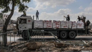 Palestinians seen on trucks loaded with International Humanitarian Aid entering Gaza through the Israeli Kerem Shalom Crossing, in the southern Gaza Strip, July 1, 2024. Photo by Abed Rahim Khatib/Flash90
