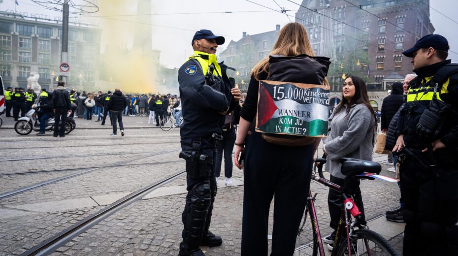 Dutch police officers speak with a pro-Palestinian activist as fans of Maccabi Tel Aviv gather before the UEFA Europa League match against Ajax in Amsterdam, on November 7, 2024. EPA-EFE/JEROEN JUMELET
