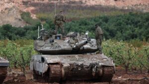 Israeli soldiers on a tank during their return from Lebanon to Israel following a ceasefire, seen from an unidentified location in Upper Galilee, Israel, November 27, 2024. Photo: EPA-EFE/ATEF SAFADI