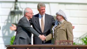 US President Bill Clinton looks on as Israeli Prime Minister Yitzhak Rabin and PLO head Yasser Arafat shake hands at the signing of the Oslo Accords on Sept. 13, 1993. Credit: William J. Clinton Presidential Library/National Archives & Records Administration.