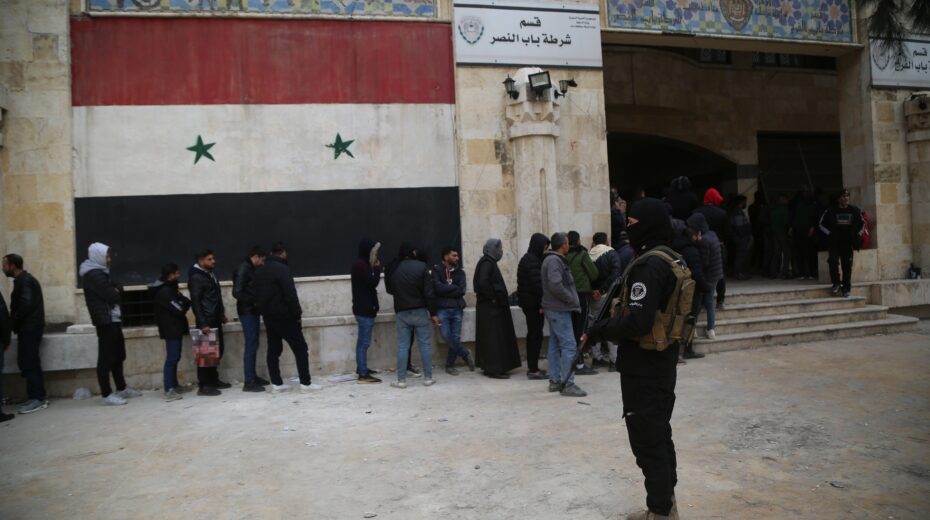 Opposition National Liberation rebels secure a former government building in Aleppo, Syria, on December 5, 2024, where people wait for their status registration after the opposition captured the city. Photo: EPA-EFE/BILAL AL ​​HAMMOUD