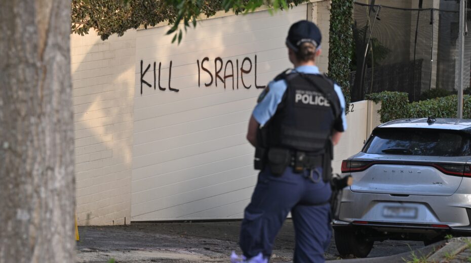 A policewoman stands next to anti-Israel graffiti in Sydney, Australia, December 11, 2024. Photo: EPA-EFE/MICK TSIKAS