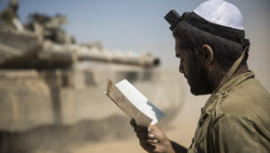 An Israeli soldier prays in an IDF staging area near the border with Gaza, July 27, 2014. Photo by Hadas Parush/Flash90.