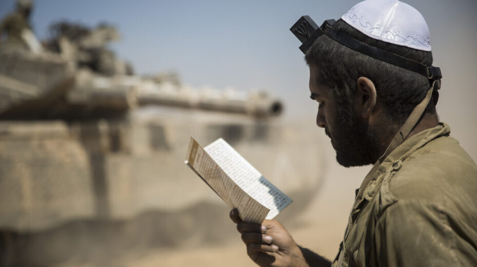 An Israeli soldier prays in an IDF staging area near the border with Gaza, July 27, 2014. Photo by Hadas Parush/Flash90.
