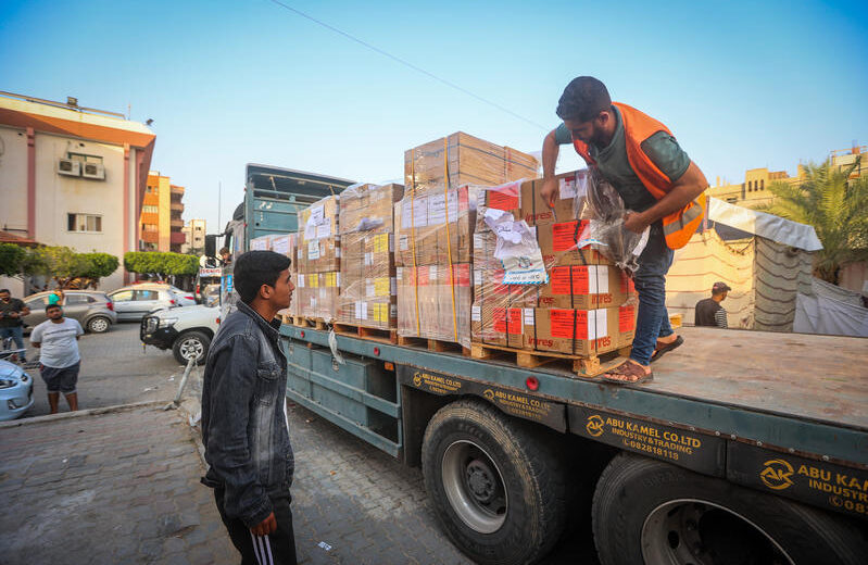Palestinians unload aid from a truck in the Gaza Strip. Photo by Atia Mohammed/Flash90