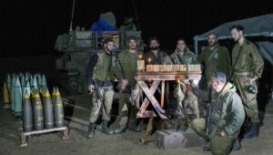 Israeli soldiers light a Chanukah menorah in the Gaza Strip. Photo by Flash90