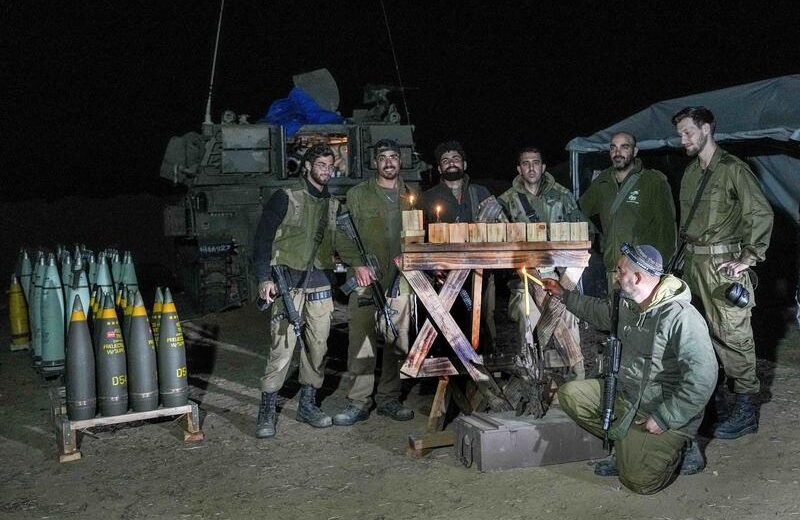 Israeli soldiers light a Chanukah menorah in the Gaza Strip. Photo by Flash90