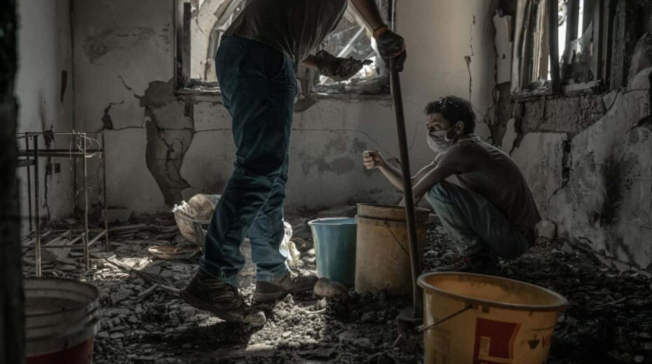 Members of a family whose father was murdered by Hamas terrorists on Oct. 7 search the rubble of his home in Kibbutz Be'eri on Nov. 30, 2023. Photo by Chen Schimmel/Flash90.