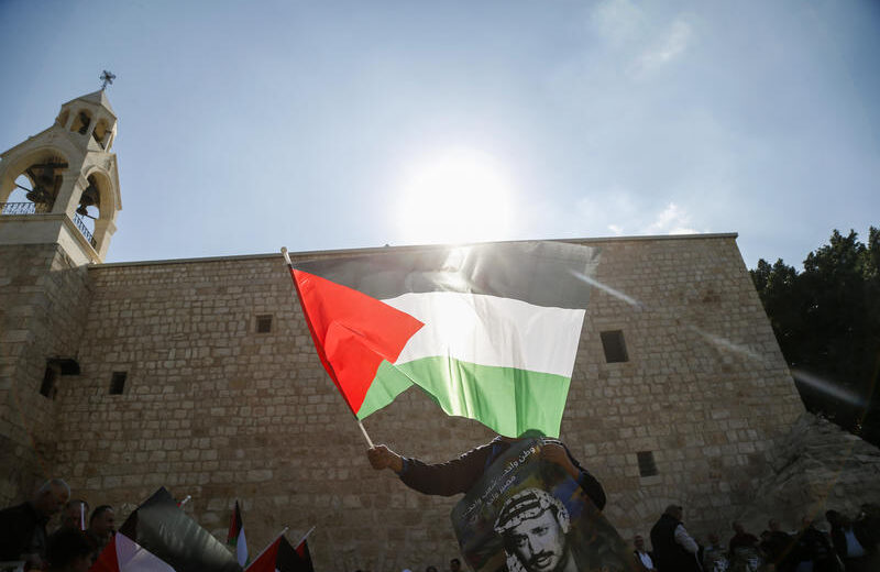 A Palestinian flag is waved outside the Church of the Nativity in Bethlehem. Photo by Wisam Hashlamoun/Flash90