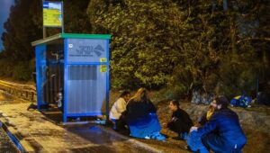 Israelis take cover on the side of a highway as a ballistic missile from Yemen is intercepted overhead, on the night of December 30, 2024. Photo by Yossi Aloni/Flash90