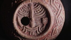 The ancient oil lamp, decorated with a menorah, incense shovel and lulav. Photo by Emil Aladjem/IAA.