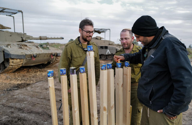 Israeli reservists light a Hanukkah menorah on the Syrian border. Photo by Michael Giladi/Flash90