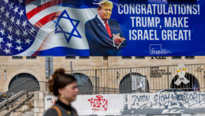 People walk next to a sign congratulating U.S. President Donald Trump for his victory in the US presidential election in central Jerusalem, November 7, 2024. Photo by Yonatan Sindel/Flash90