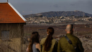 Israelis in Metula view damage from an IDF operation across the border in Lebanon, Dec. 9, 2024. Photo by Chaim Goldberg/Flash90.